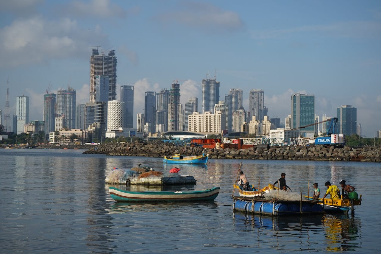 Photograph of Mumbai skyline over boats on the river